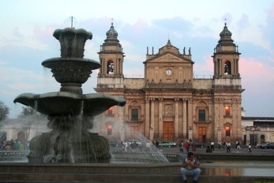 View of the cathedral with the Plaza Mayor fountain in the foreground.