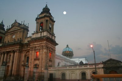 Side view of the cathedral at dusk with the moon overhead.
