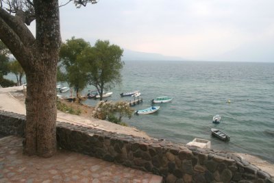 View of Lake Atitln with some small boats moored along the shoreline.
