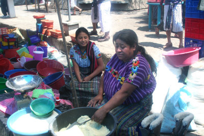 A woman and young girl selling what appeared to be corn meal.