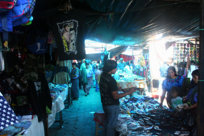 Sandals and many other sundries for sale under the tarpaulin in the Indian Market.