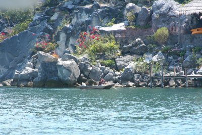 Another Lake Atitln view, this one of a man paddling his dingy to a dock.