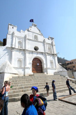 View from the base of the cathedral with tourists standing around.