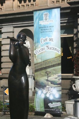 A modern flutist sculpture with a sign for Cafe del Tatro Nacional which has the best coffee in San Jos.