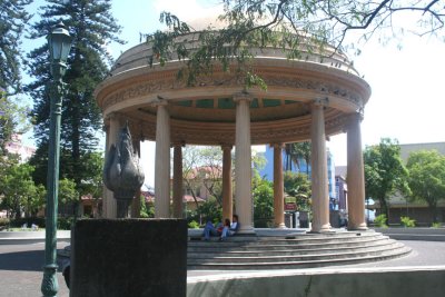 A close-up of the gazebo with a statue in the foreground.