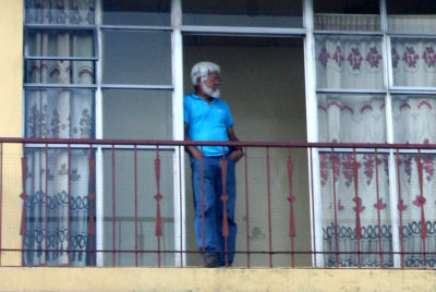 Close-up of the lone man on the balcony.