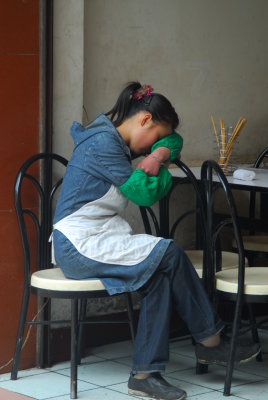 Chengdu tired vendor at the neighbourhood market
