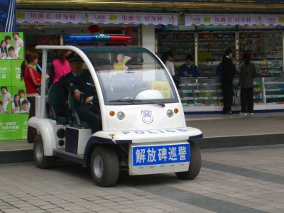 Chongqing - golf cart police (notice, she's pulling her gun)