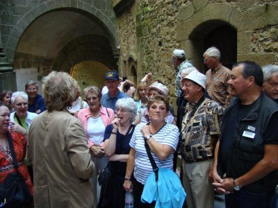 A guide tells a tour group about the monastery