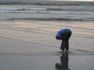 Donna dipping her feet in the Pacific