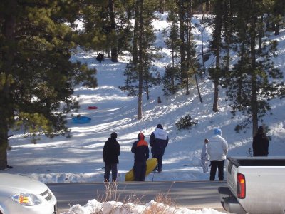 crazy kids sliding down the mountain on pools, surfboards, etc.