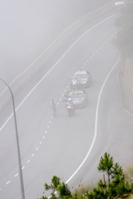 First rider appearing out of the mist at 2km to go mark