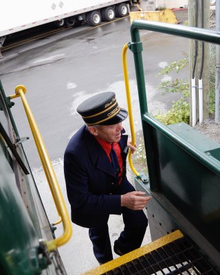 Conductor Boards the Rear of the Train