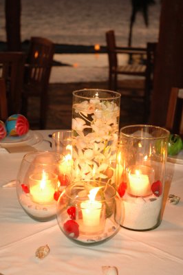 Candle centerpiece with floating orchids in the middle, Photo by Cecilia Dumas Photography, www.ceciliadumas.com