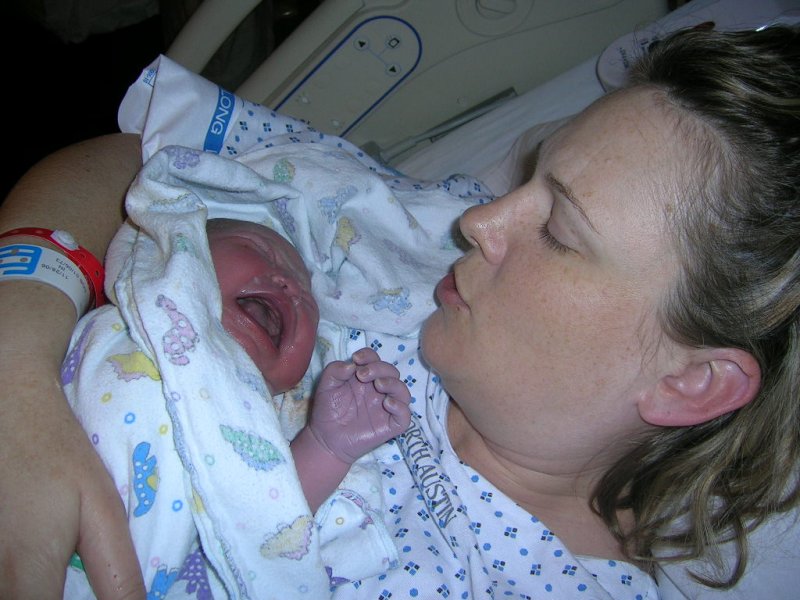 Leslie holding Eva for the first time