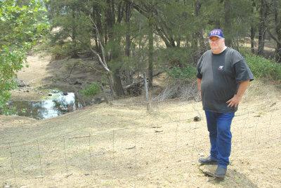 MY MATE STANDING NEAR THE CREEK  WHERE HE PLAYED AS A BOY.
