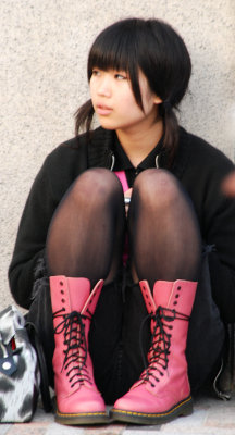 Lost in thought in nice pink boots.