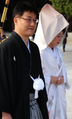 A proud groom and a shy bride