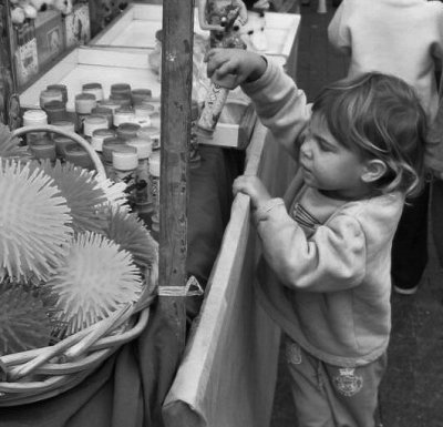 Checking A Toy At The Holiday Market.jpg