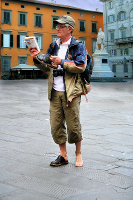 Distinguished gentleman with one guide book and one shoe...