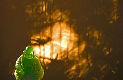 Buddha and afternoon shadows from a Bamboo blind