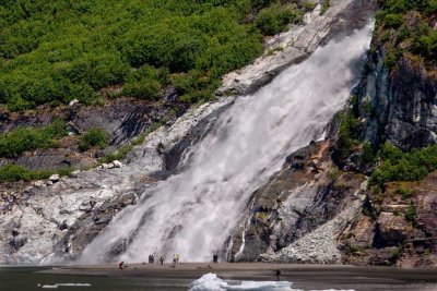 People enjoying Nugget Falls near Mendenhall Glacier