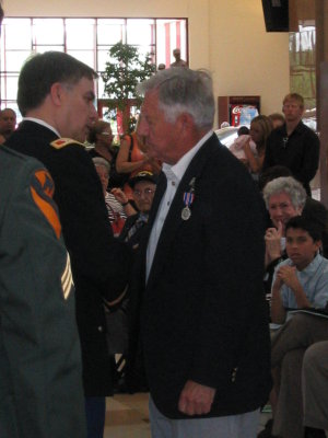 Lt Col Abel talks to Dad after pinning on the medal