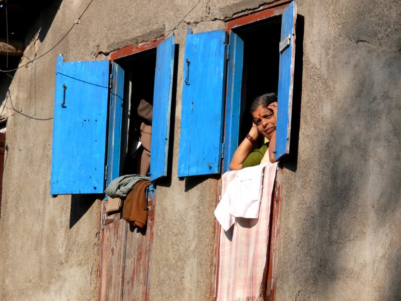 Woman and blue shutters