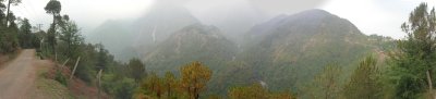 Panoramic view, from Naddi,  of the Dhuala Dhar mountain range foothills