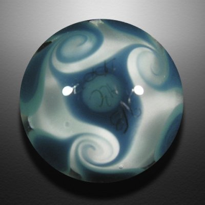 A tiny imploded fancy script 'g' sits inside this teensy-tiny marble with pinwheeled backside.