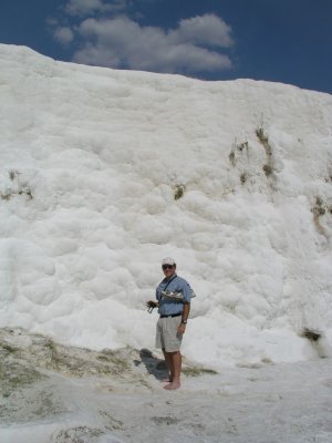 Bob in front of a wall of the travertine material.