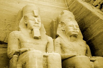 statues of Ramses II sit majestically, staring out across the desert as if looking thru time itself
