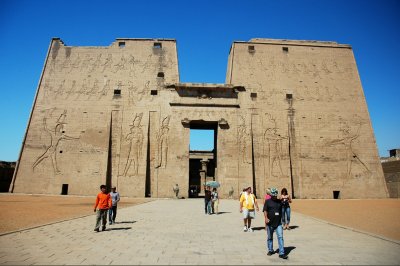 Pylon of teh Temple of Horus in Edfu with reliefs showing pharaoh Ptolemy XII