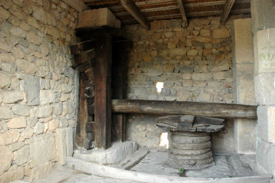 reconstruction of an olive press, showing the baskets used for pressing the olives