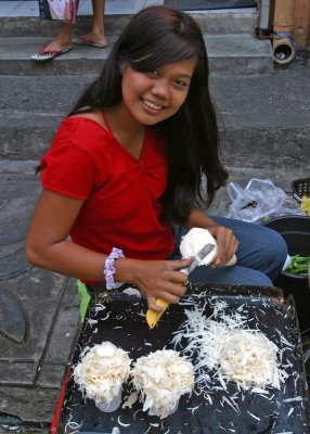 young woman shaving labong (bamboo shoots)