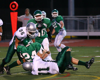 Seton's Garrett Lubuiewske gets tackled by Newfield's Dillon Shults and Blake Allen after making a good run