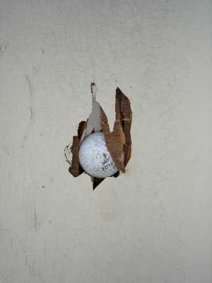 Golfball stuck in plywood building