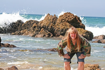 This marine biologist should know better than to turn her back to the waves