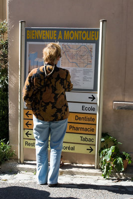 Mary checking out the sign in Montolieu