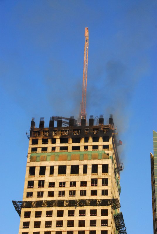 A fire on top of a building under construction