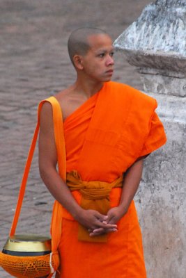 Monk waiting with alms bowl
