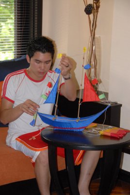 Jeng assembling a boat-shaped kite