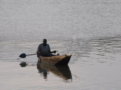 Man padding a canoe (pirogue) Mali