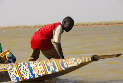 Boy in the bow of a 2006 pirogue, Niger River, Mali