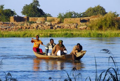 Pirogue ferries men across the Niger from the island to Ayorou