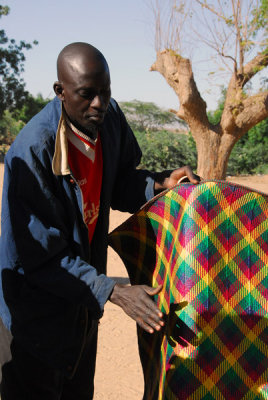 Man showing locally produced kente cloth, Niger