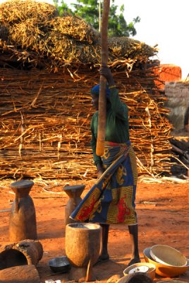 Village woman pounding millet, Niger