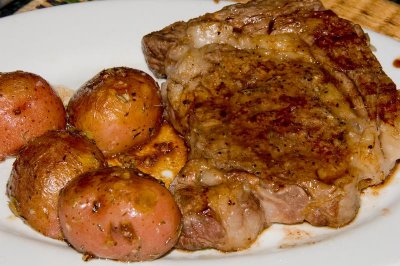 grilled ribeye steak and roasted potatoes