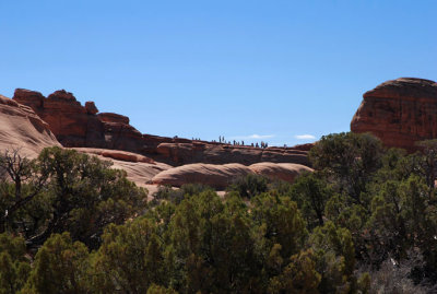 Worshippers of Delicate Arch, as seen from the alcove outcrop