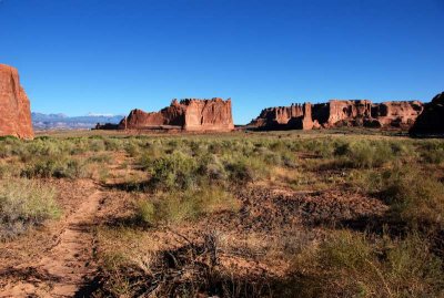 Courthouse Towers in distance, from a game trail next to Courthouse Wash)